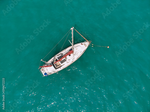 Amazing sail boat is sailing across the deep blue sea. Top view.