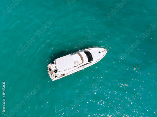 Adorable aerial top view photo of a laxury huge two-storey yach sailing across the deep blue sea © Semachkovsky 