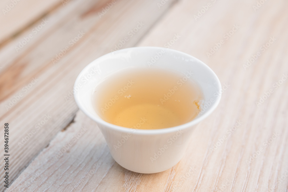 Beautiful porcelain tea cup close up shot. Hydrating pale liquor in it.
Fresh natural yellow tea. Beautiful porcelain tea cup close up shot. Hydrating pale liquor in it.
Fresh natural yellow tea.
