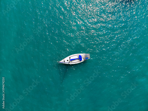 Bild auf Leinwand Aerial wonderful view of a enormous white and blue yacht sailing across the blue