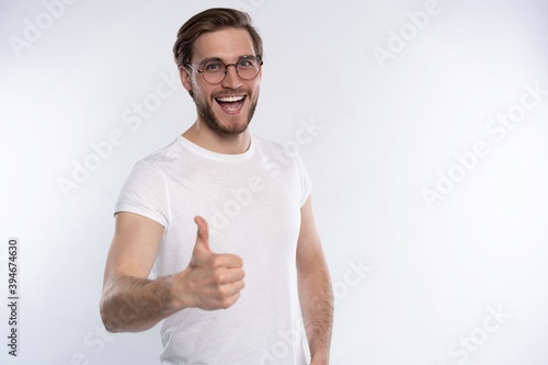Happy man giving thumbs up sign isolated on white background.