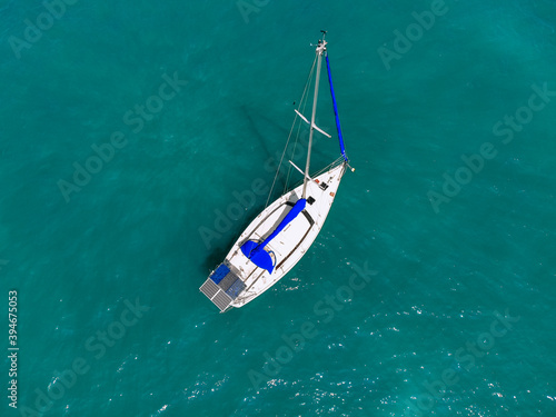 Bild auf Leinwand Aerial wonderful view of a enormous white and blue yacht sailing across the blue