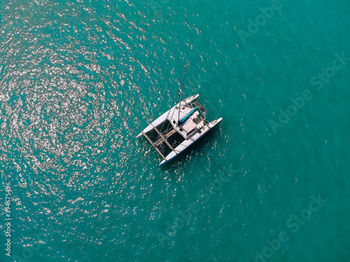 Bild auf Leinwand Bird's eyes view of the amazing white catamaran sailing across the blue lagoona