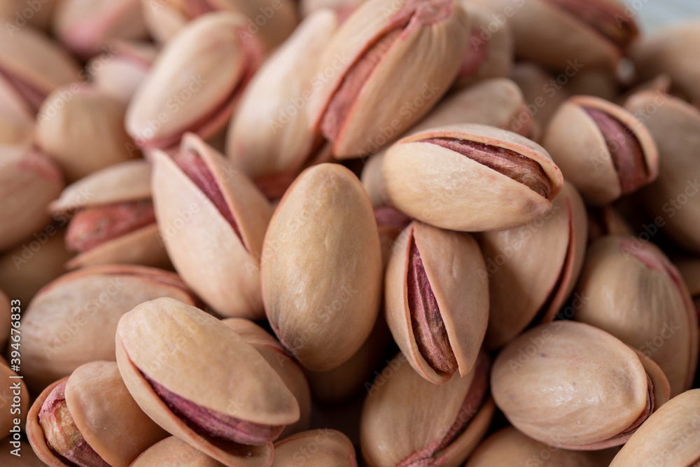 pistachios in bowl - on wooden background - close up pistachios in bowl - on wooden background - close up