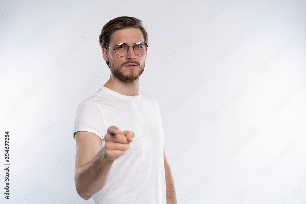 Smiling man pointing his finger to you isolated on white. Smiling man pointing his finger to you isolated on white.