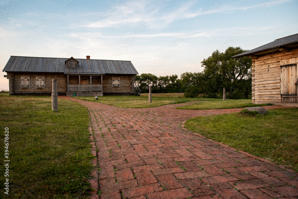 red brick path in an old village with wooden houses red brick path in an old village with wooden houses