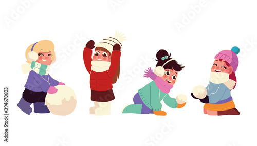 happy little girls playing with the snowballs in winter season