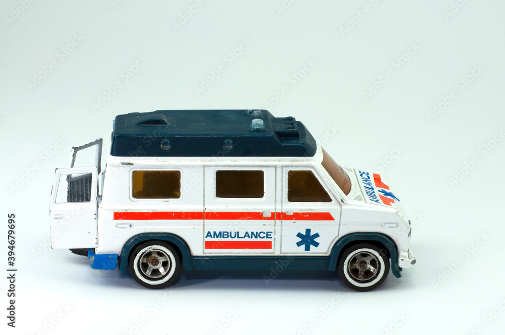 Old toy ambulance car isolated on white background 