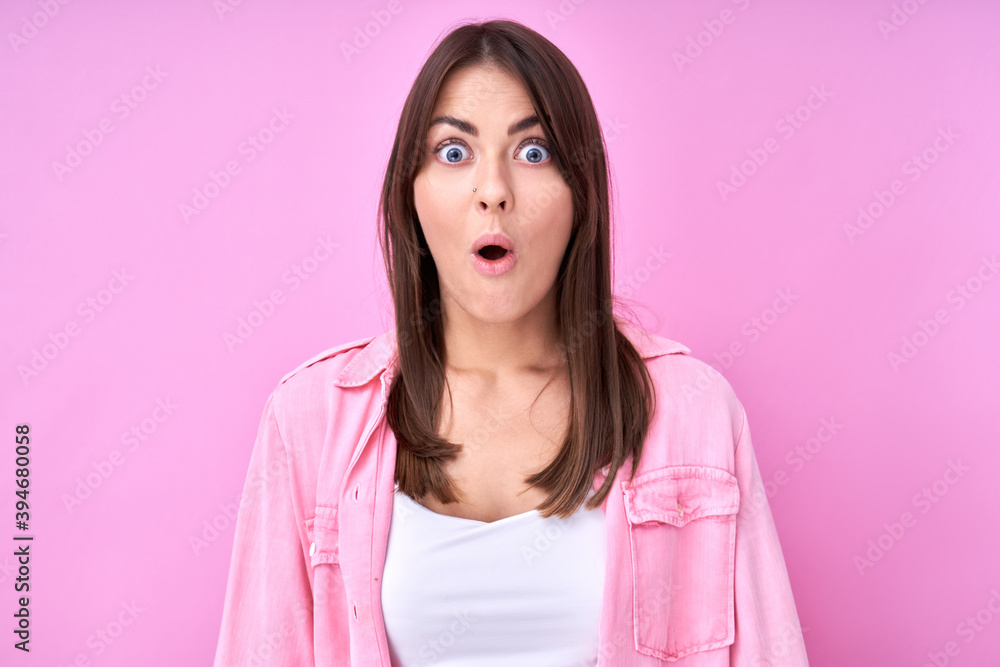 Caucasian shocked brunette girl with open mouth, dressed in casual, heard amazing news, happy to receive incredible surprise present isolated in pink studio Caucasian shocked brunette girl with open mouth, dressed in casual, heard amazing news, happy to receive incredible surprise present isolated in pink studio