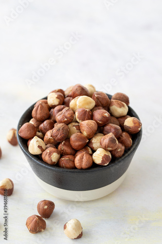 Hazelnuts in plate on white background
