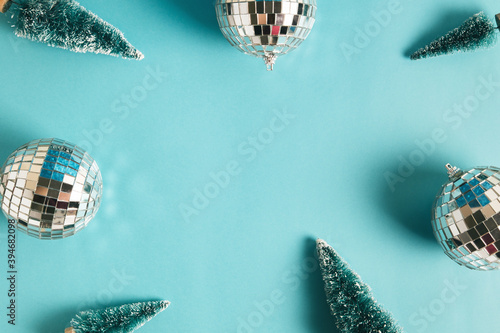 Christmas minimal festive background with disco ball, toy tree. Abstract christmas background shiny blue ai aqua. Flat lay. Top view. Copyspace.