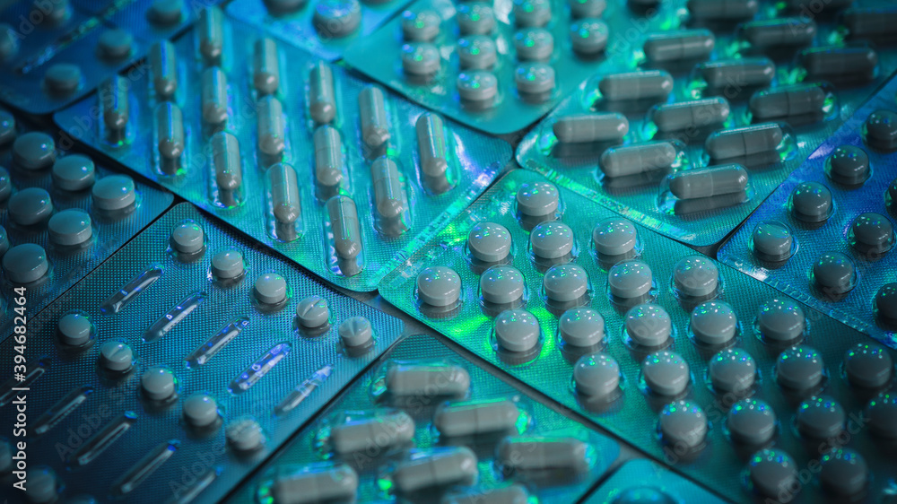 packs pills spread out on a surface in blue-green light, macro, blurred image, medicines packs pills spread out on a surface in blue-green light, macro, blurred image, medicines