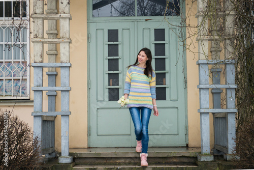 Young woman in knitted sweater on a winter walk 