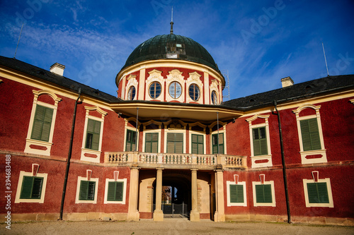 Veltrusy Rococo castle with park and garden, Romantic baroque chateau red with white windows in sunny autumn day, entrance with balcony, Central Bohemia, Czech republic