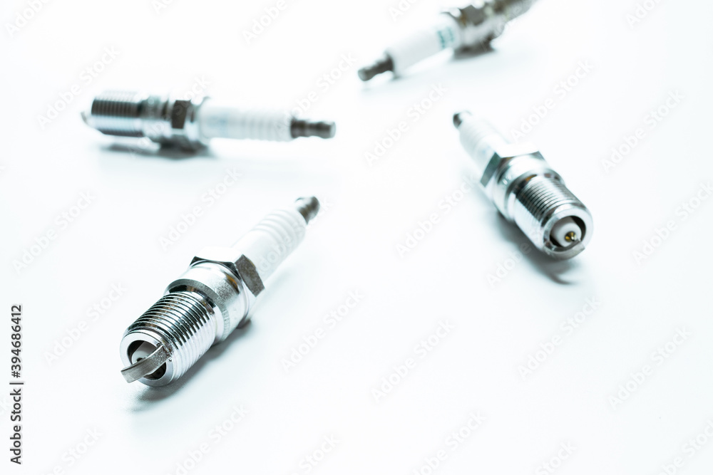 Car engine. Set of new metal car part. Auto spark plugs or automotive piece isolated on white background. Automobile engine service. Car engine. Set of new metal car part. Auto spark plugs or automotive piece isolated on white background. Automobile engine service.