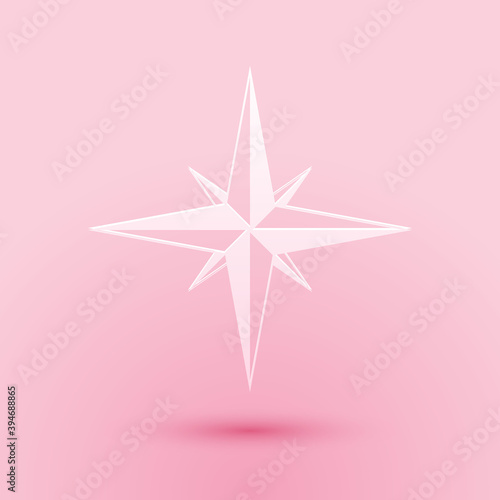 Paper cut Wind rose icon isolated on pink background. Compass icon for travel. Navigation design. Paper art style. Vector.