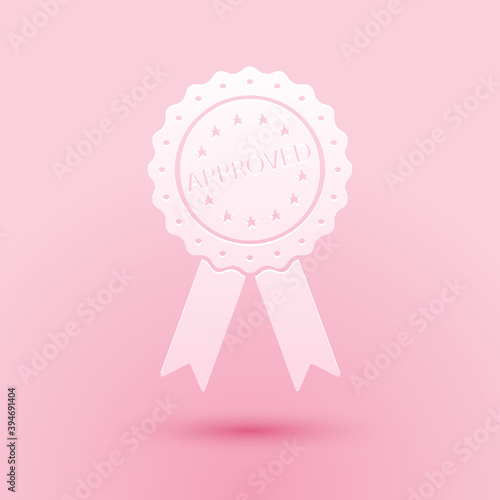 Paper cut Approved or certified medal badge with ribbons icon isolated on pink background. Approved seal stamp sign. Paper art style. Vector.