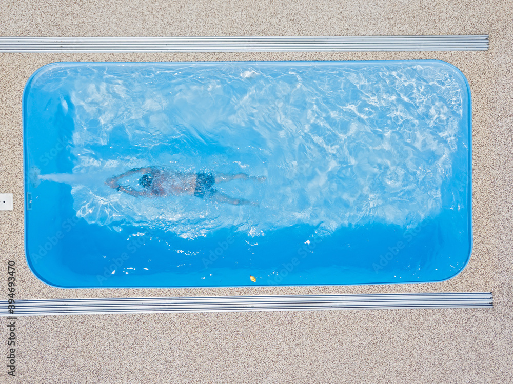 A young man enjoys summer fun by the hotel pool.