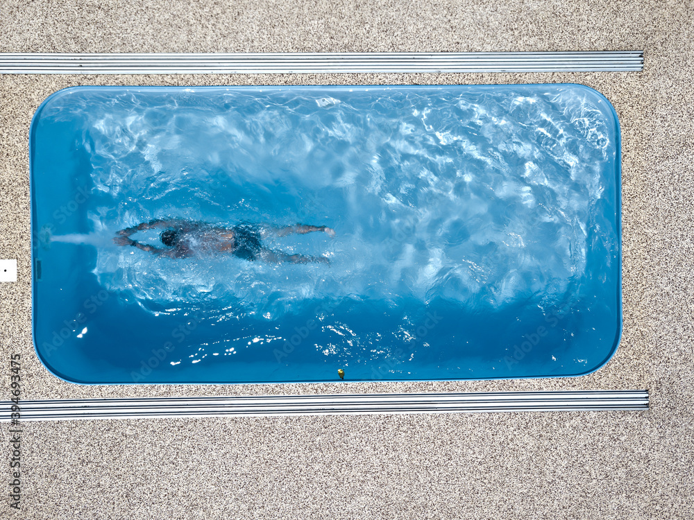 A young man enjoys summer fun by the hotel pool.