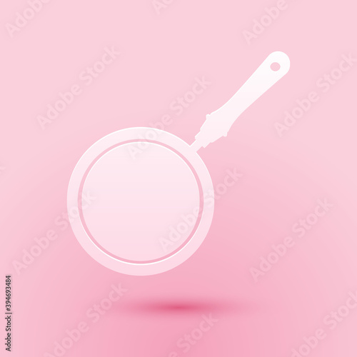 Paper cut Frying pan icon isolated on pink background. Paper art style. Vector.