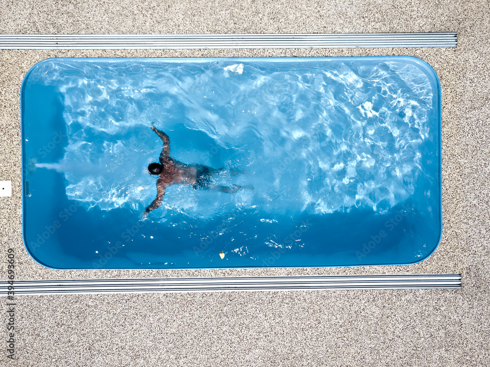 A young man enjoys summer fun by the hotel pool.
