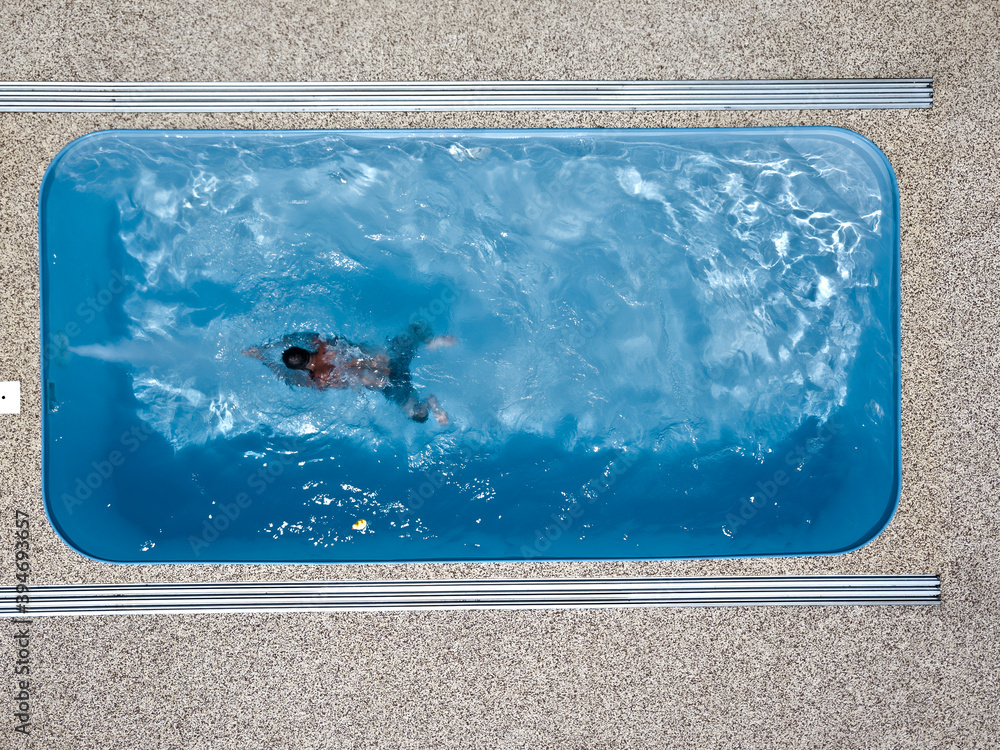 A young man enjoys summer fun by the hotel pool.