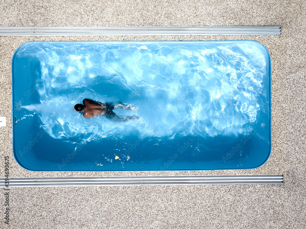 A young man enjoys summer fun by the hotel pool.