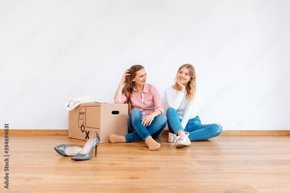 Two women in new apartment dreaming of how to decorate it Two women in new apartment dreaming of how to decorate it