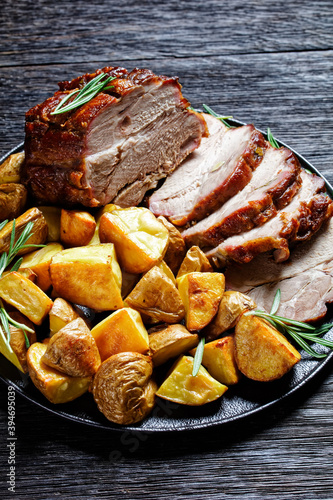 Whole roasted pork loin with baked potato wedges