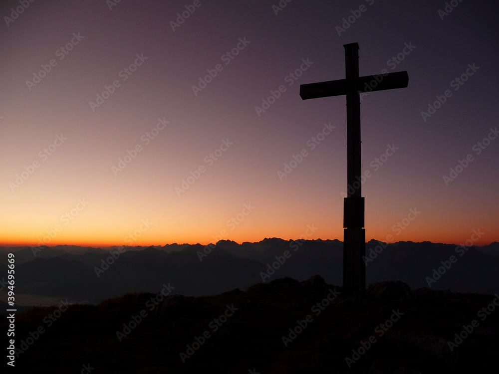 Summit cross at sunset Krottenkopf mountain, Bavaria, Germany