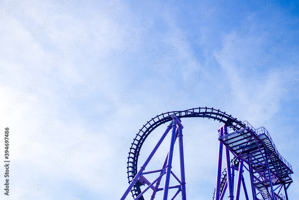 summer blurred photo of Rollercoaster against blue sky summer blurred photo of Rollercoaster against blue sky