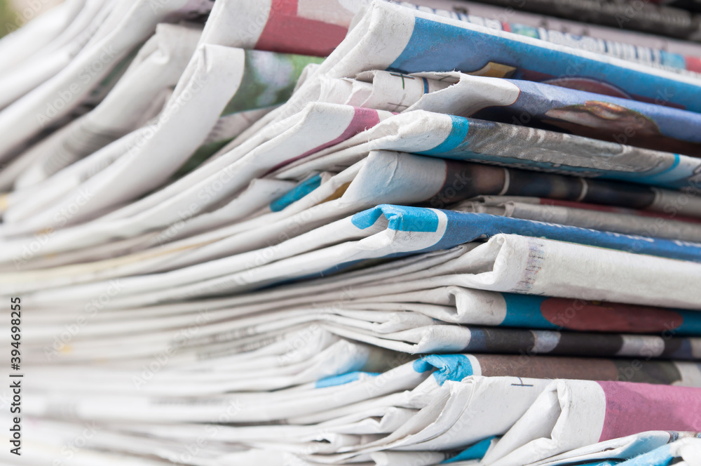 Newspapers folded and stacked on the table. Closeup newspaper and selective focus image.. Newspapers folded and stacked on the table. Closeup newspaper and selective focus image..