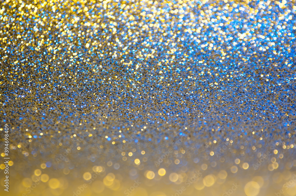Gold, yellow,blue abstract light background, Golden shining lights, sparkling glittering Christmas lights. Blurred abstract holiday background.