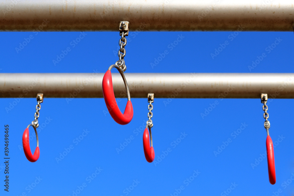 Sports metal ring with red rubber grip on blue sky background