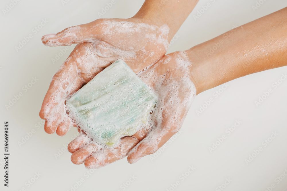 Fototapeta premium Female hands holding a soap.