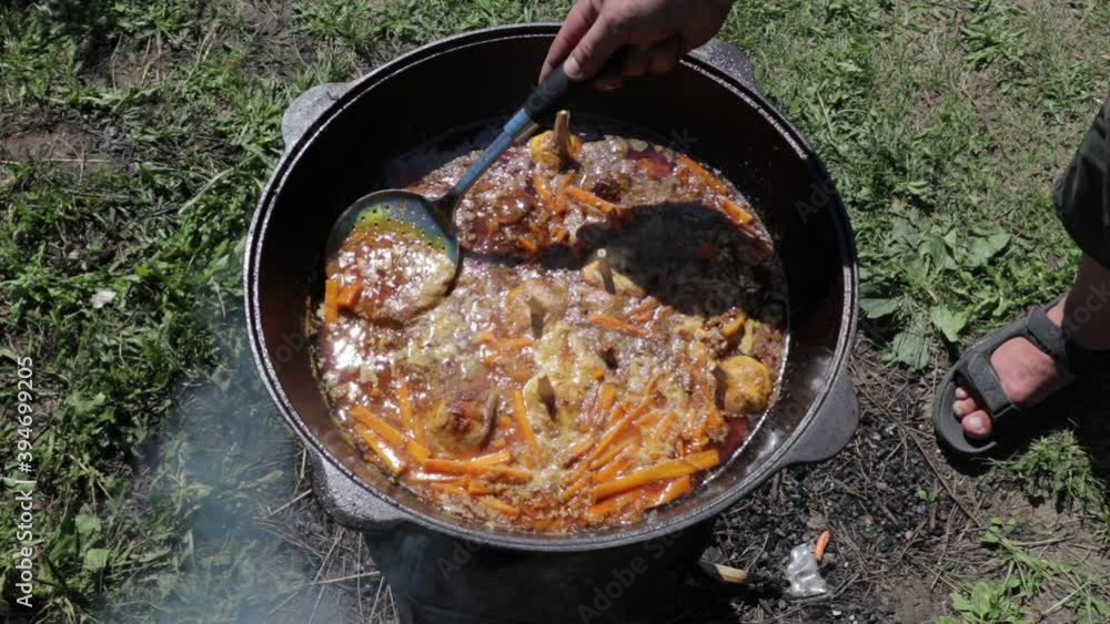 pilaf in a cauldron on fire, oriental dish pilaf in a cauldron on fire, oriental dish
