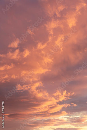 Sunset sky, clouds illuminated by the sun. Warm colors.