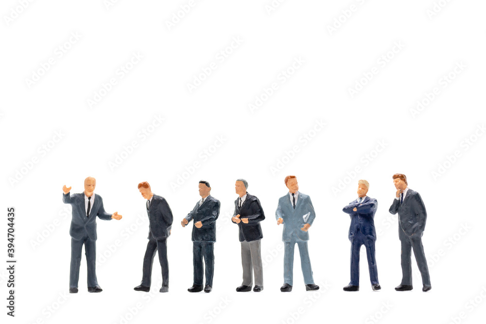 Miniature people, Businessman standing on white background Miniature people, Businessman standing on white background