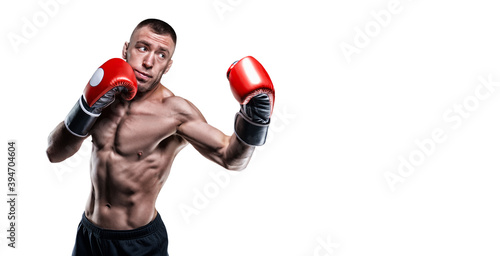 Professional boxer in red gloves exercises punches on a white background. Boxing concept. photo