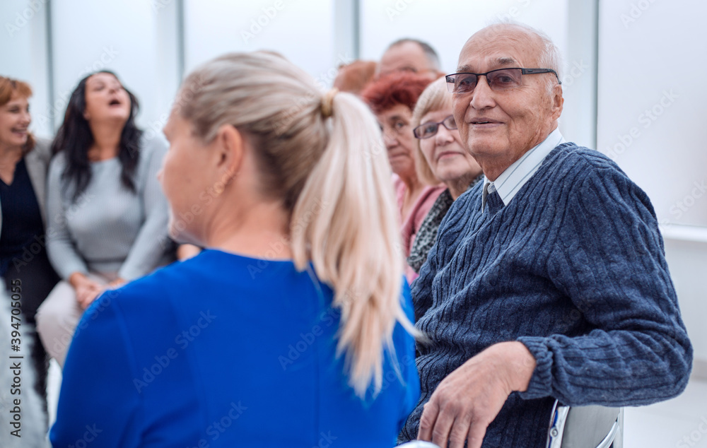 Fototapeta premium a mature man looks at the camera in a group of people