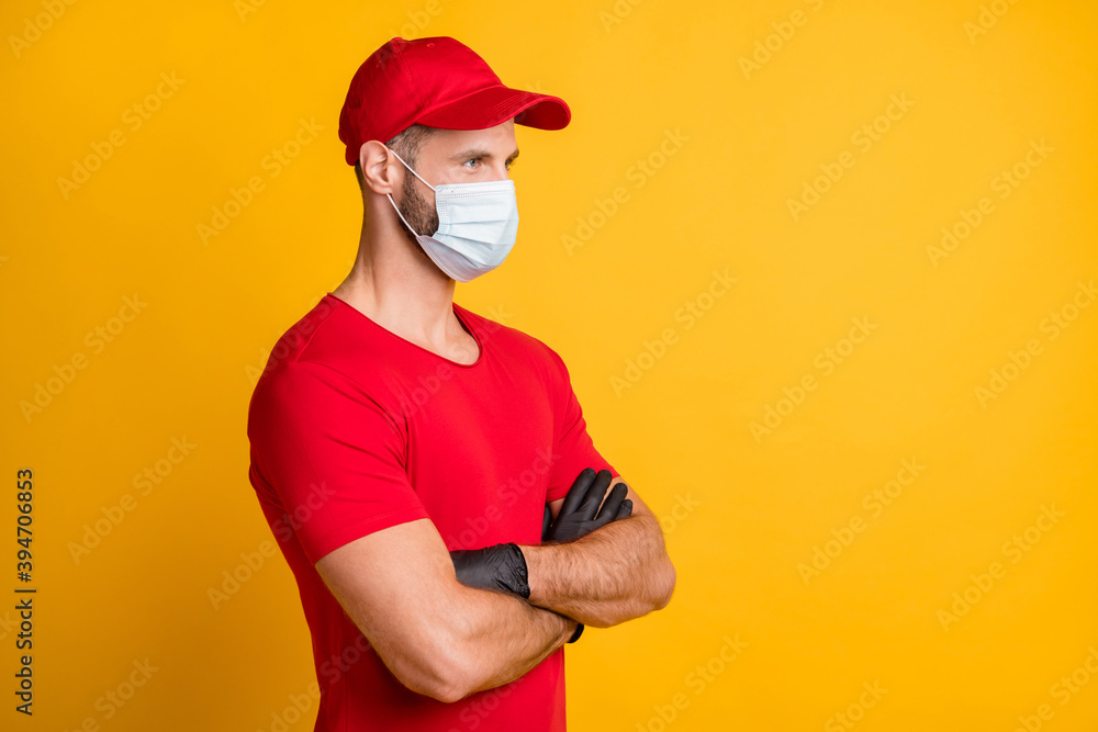 Profile photo of self-assured guy crossed arms wear mask red t-shirt hat isolated yellow color background