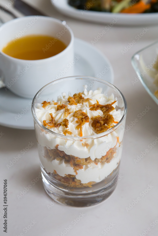 Glass of granola with white cream Glass of granola with white cream
