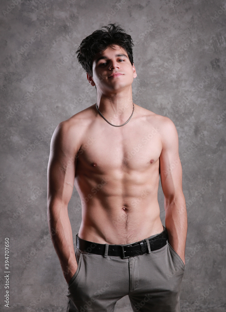 Fototapeta premium A young and masculine guy poses in the torso.