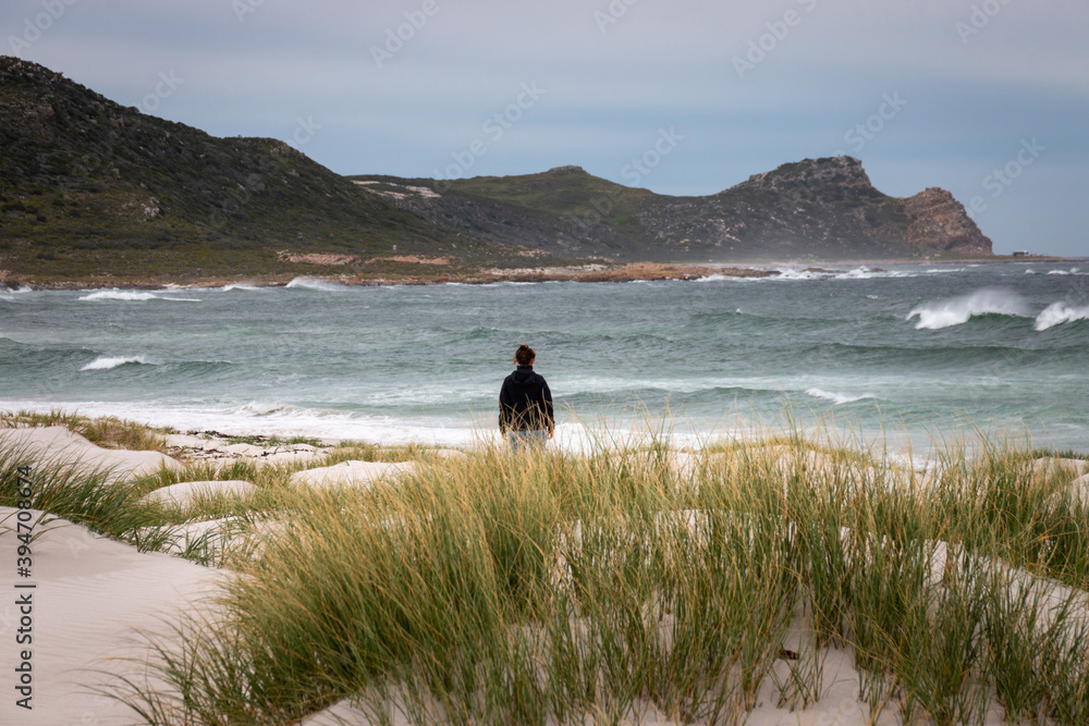 Woman standing at Platboom beach, Cape of Good Hope, South Africa. Woman standing at Platboom beach, Cape of Good Hope, South Africa.