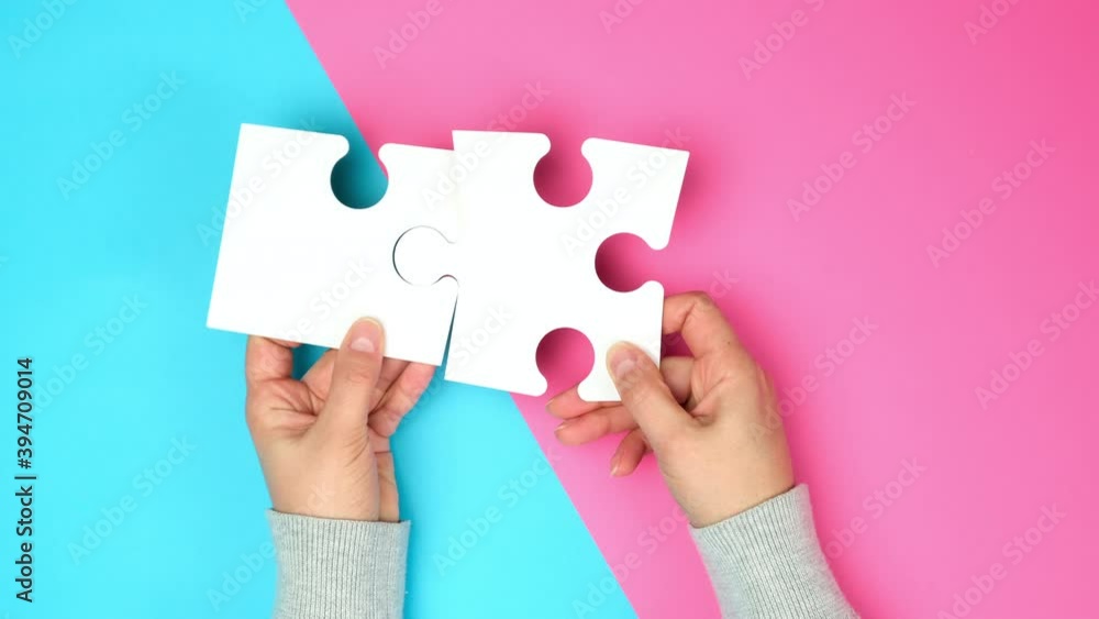 empty paper white pieces of puzzles in female hands, puzzle connected, colorful background, top view empty paper white pieces of puzzles in female hands, puzzle connected, colorful background, top view
