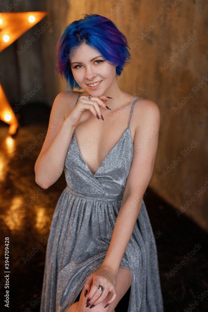 model with blue hair in a silver dress at a party model with blue hair in a silver dress at a party