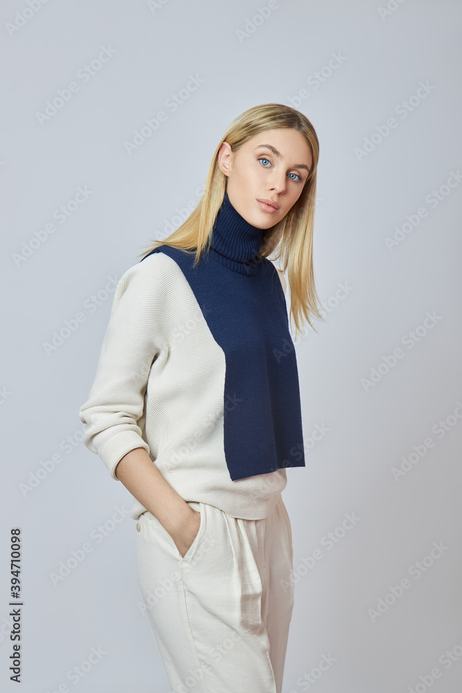 Blonde woman with a shirt front around her neck. Clothing for autumn weather. Beautiful natural makeup Blonde woman with a shirt front around her neck. Clothing for autumn weather. Beautiful natural makeup