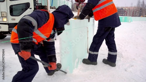Portrait of a worker busy assembling an ice block on an ice town