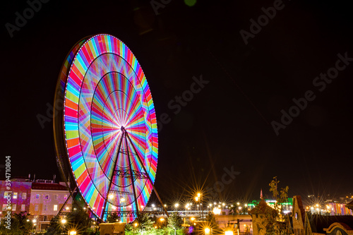 summer blurred photo of Rollercoaster against night