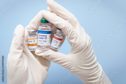 Potential vaccines for COVID-19 in clinical trials stage concept. Hand of a Researcher holding Coronavirus 2019-nCoV Vaccine ready to test with volunteer. Development process, Candidates, Selected.